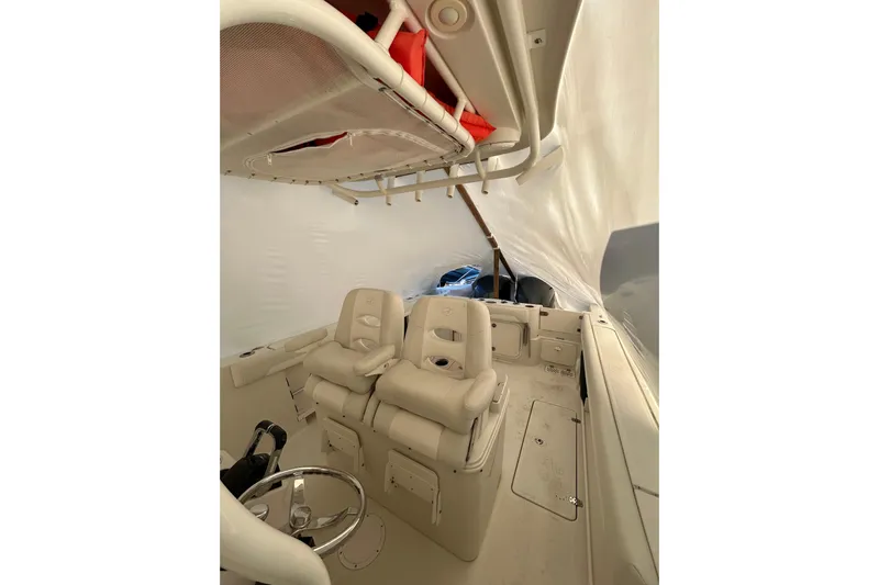  Yacht Photos Pics 2015 Sailfish 290 CC boat interior with seating and steering wheel.