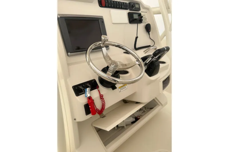  Yacht Photos Pics 2015 Sailfish 290 CC boat console with steering wheel and navigation controls.