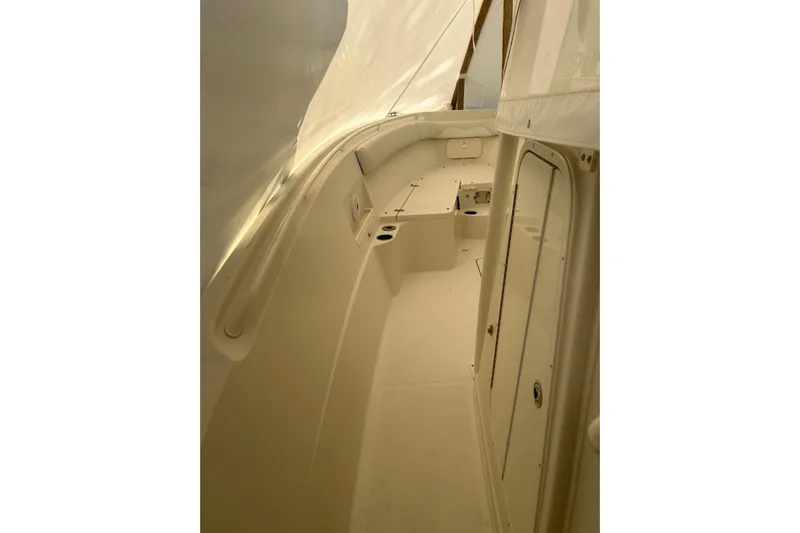  Yacht Photos Pics 2015 Sailfish 290 CC boat interior, featuring sleek white design and storage compartments.