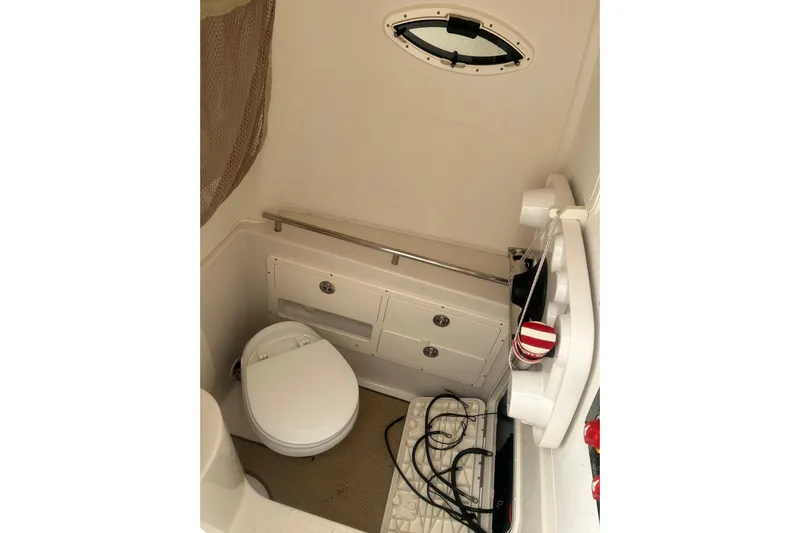  Yacht Photos Pics 2015 Sailfish 290 CC boat interior with compact bathroom and storage.