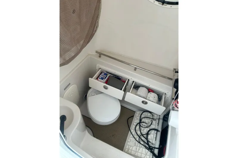  Yacht Photos Pics 2015 Sailfish 290 CC boat interior with storage drawers and toilet.