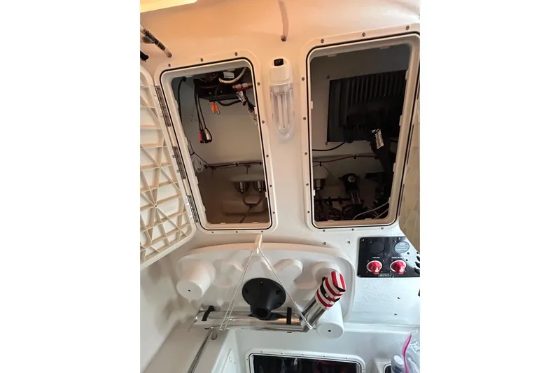  Yacht Photos Pics Interior view of a 2015 Sailfish 290 CC boat showing storage compartments and controls.