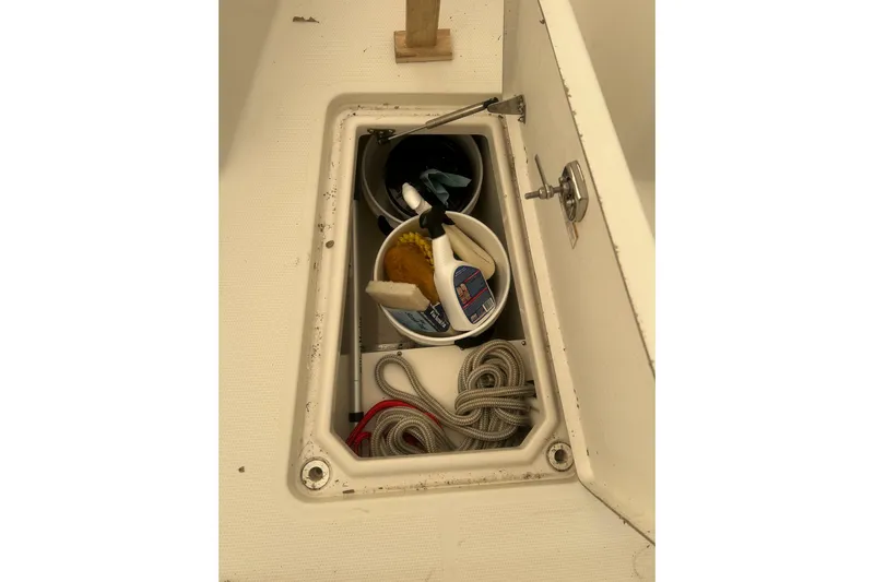  Yacht Photos Pics Storage compartment on 2015 Sailfish 290 CC boat with cleaning supplies and rope.
