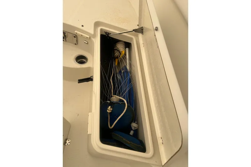  Yacht Photos Pics Open storage compartment on 2015 Sailfish 290 CC boat, containing fishing gear.