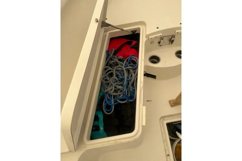  Yacht Photos Pics Open storage compartment on 2015 Sailfish 290 CC boat with ropes and gear.