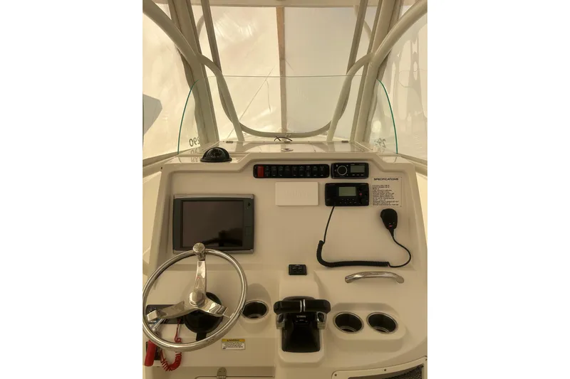  Yacht Photos Pics 2015 Sailfish 290 CC boat dashboard with steering wheel and navigation controls.
