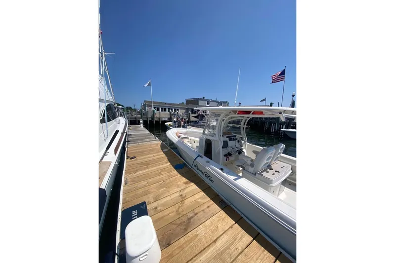  Yacht Photos Pics 2015 Sailfish 290 CC boat docked at marina under clear blue sky.