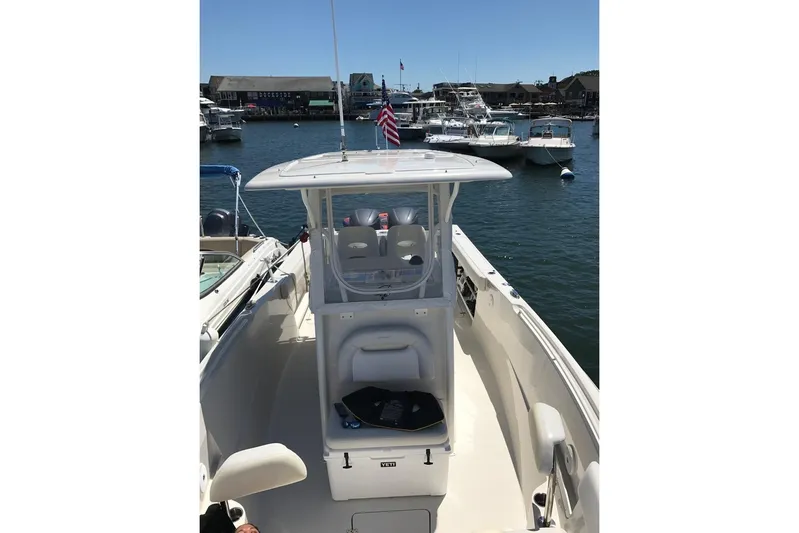  Yacht Photos Pics 2015 Sailfish 290 CC boat docked in a marina, surrounded by other vessels.
