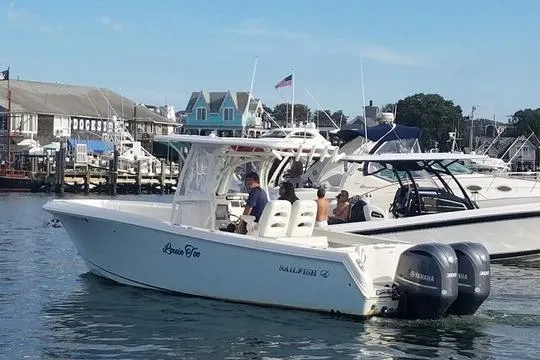  Yacht Photos Pics 2015 Sailfish 290 CC boat with twin Yamaha engines docked in a marina.