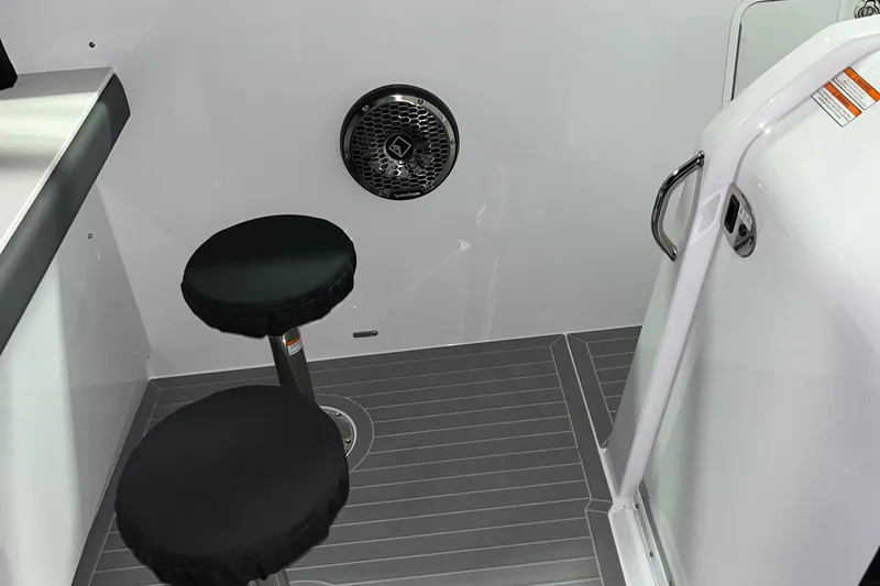  Yacht Photos Pics 2023 Cruisers Yachts 38 GLS interior with two black stools and sleek flooring.