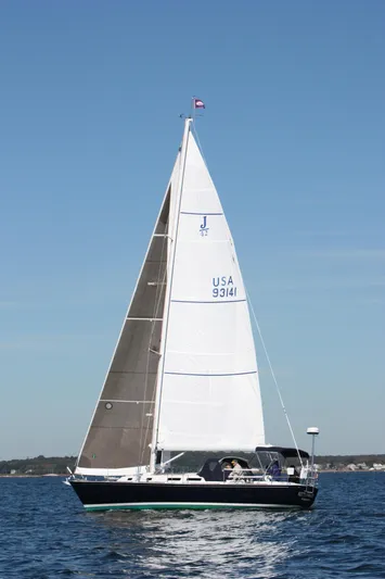 Kittywake Yacht Photos Pics Sailing yacht J Boats J/42, 1996 model, gliding on calm waters under clear blue skies.