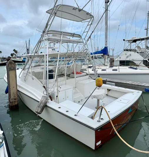 Pandemonium Yacht Photos Pics 2000 Liberty 42 Express boat docked at marina, featuring sleek design and fishing tower.