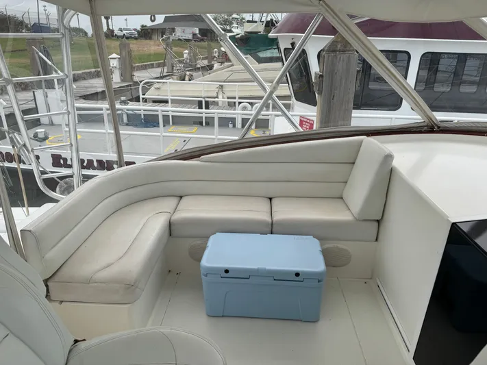 Pandemonium Yacht Photos Pics 2000 Liberty 42 Express boat interior with white seating and a blue cooler.