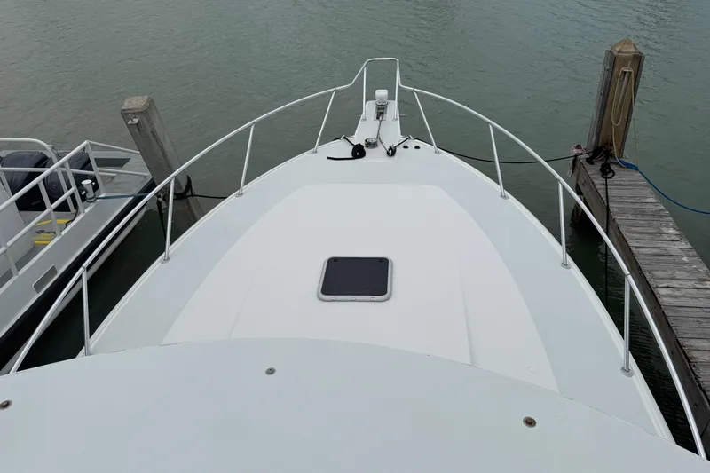 Pandemonium Yacht Photos Pics Bow view of 2000 Liberty 42 Express yacht docked at marina.