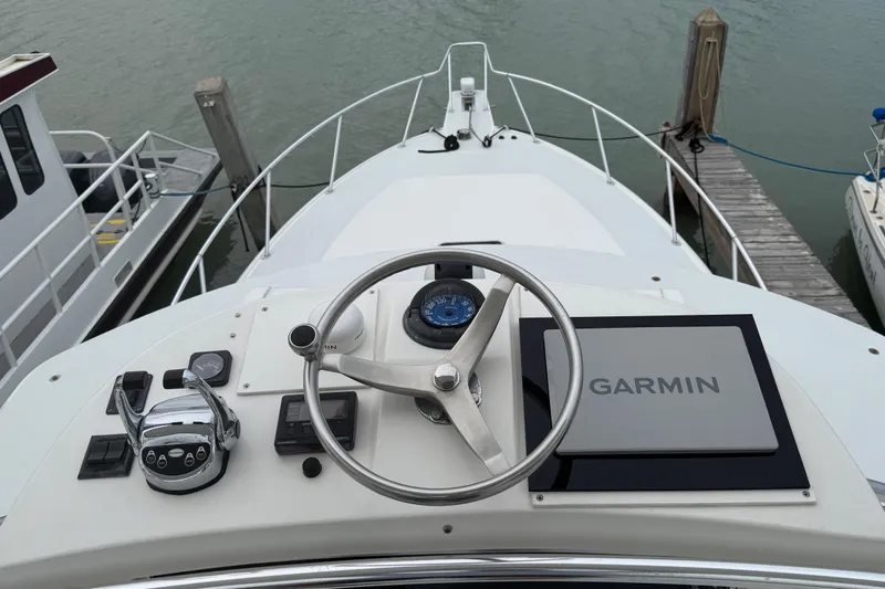 Pandemonium Yacht Photos Pics Helm of 2000 Liberty 42 Express yacht with Garmin navigation system.
