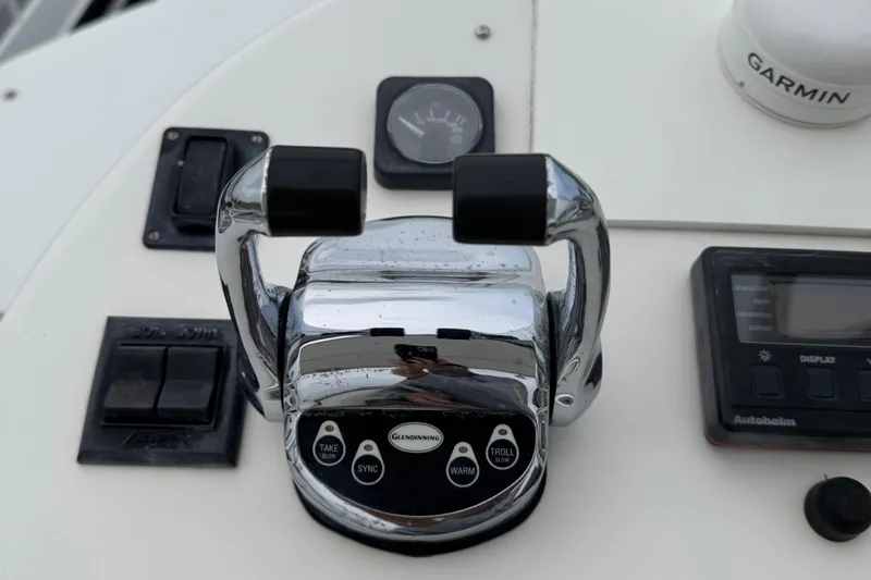 Pandemonium Yacht Photos Pics Control panel of a 2000 Liberty 42 Express boat with throttle and navigation instruments.