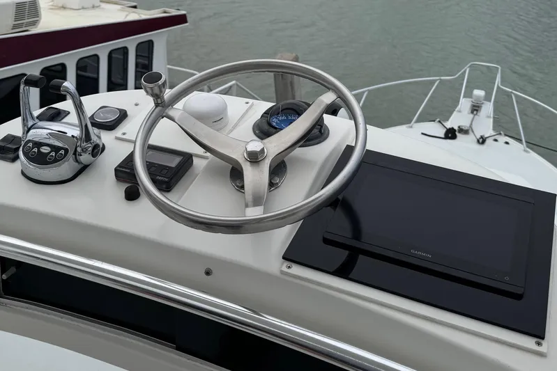 Pandemonium Yacht Photos Pics Helm of 2000 Liberty 42 Express yacht with steering wheel and controls.