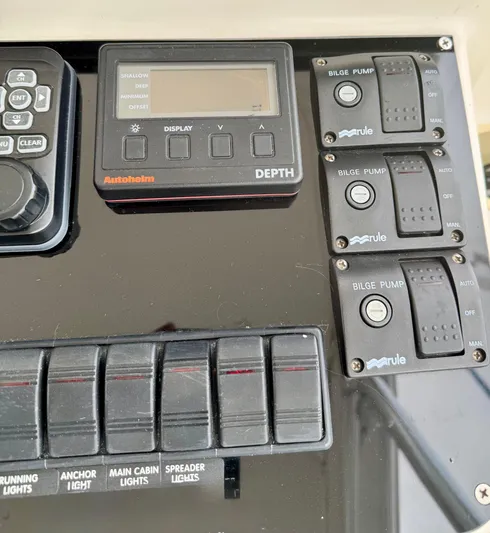 Pandemonium Yacht Photos Pics Control panel of a 2000 Liberty 42 Express boat with depth display and bilge pump switches.