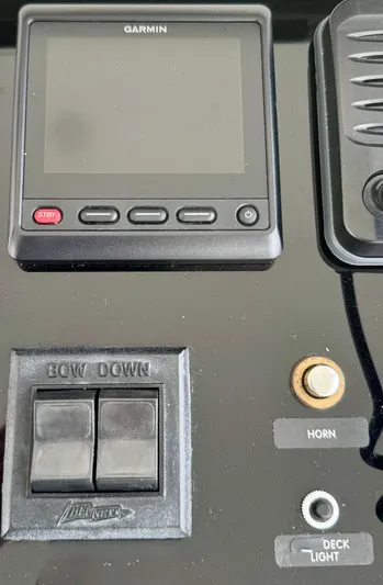 Pandemonium Yacht Photos Pics Control panel of a 2000 Liberty 42 Express boat with Garmin display and switches.