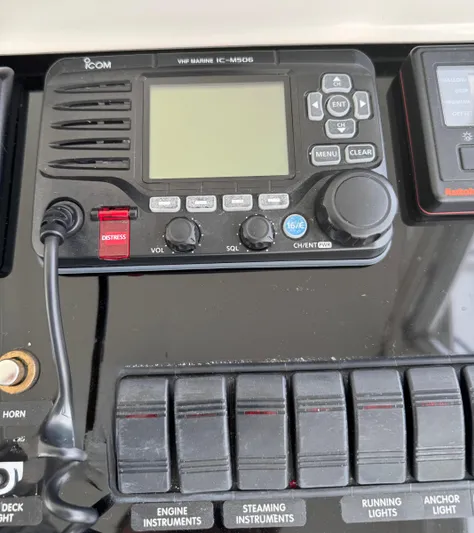 Pandemonium Yacht Photos Pics VHF marine radio on Liberty 42 Express 2000 dashboard with control switches.