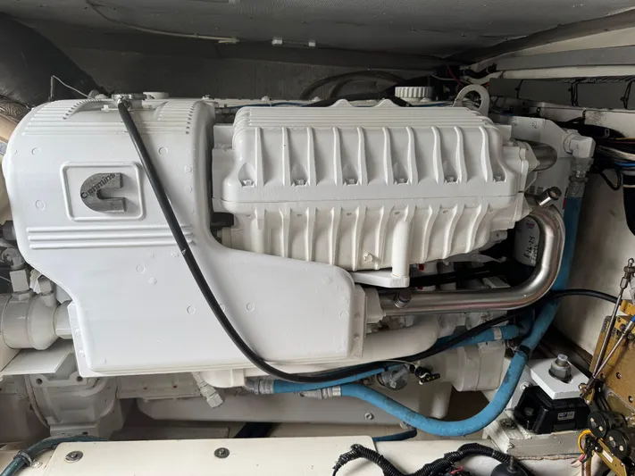 Pandemonium Yacht Photos Pics Engine of a 2000 Liberty 42 Express boat, featuring white casing and visible piping.