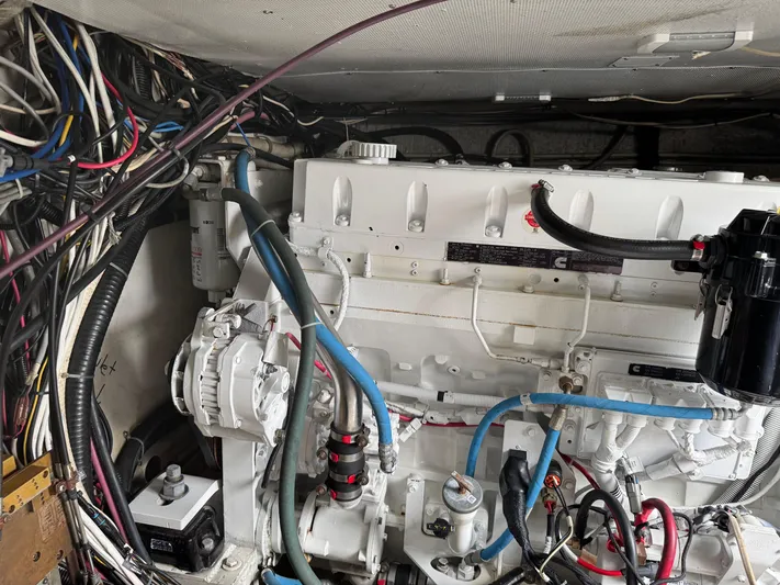 Pandemonium Yacht Photos Pics Engine room of a 2000 Liberty 42 Express boat, showcasing complex wiring and machinery.