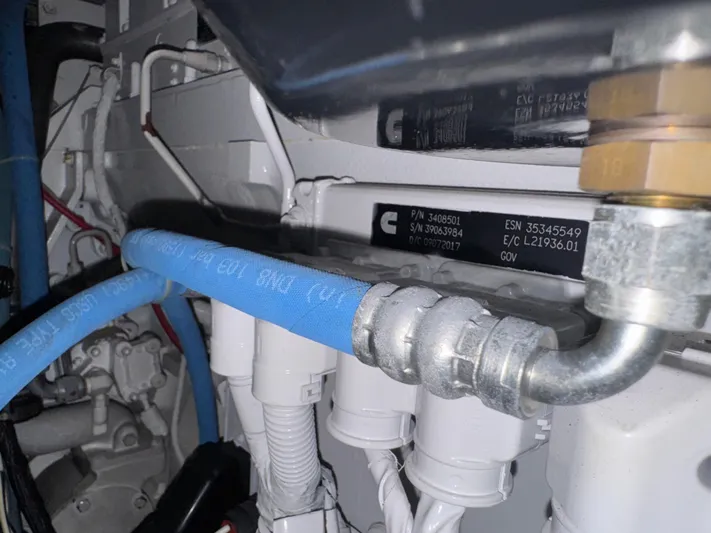 Pandemonium Yacht Photos Pics Engine compartment of a 2000 Liberty 42 Express, featuring hoses and mechanical components.