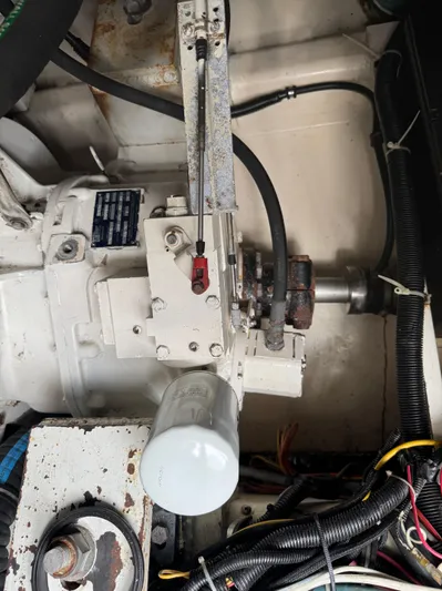 Pandemonium Yacht Photos Pics Engine compartment of a 2000 Liberty 42 Express boat, showing mechanical components and wiring.