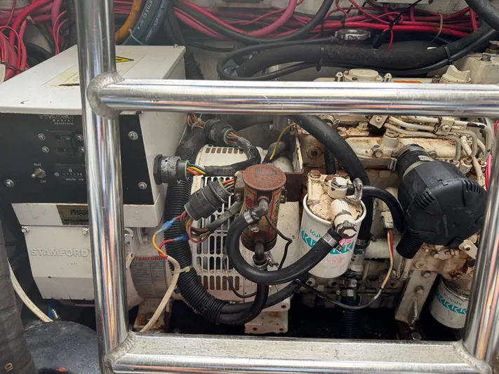 Pandemonium Yacht Photos Pics Engine compartment of a 2000 Liberty 42 Express boat, showing mechanical components and wiring.