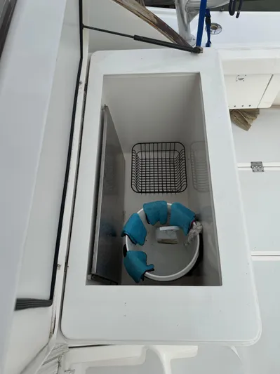 Pandemonium Yacht Photos Pics Storage compartment on a 2000 Liberty 42 Express boat with safety equipment.