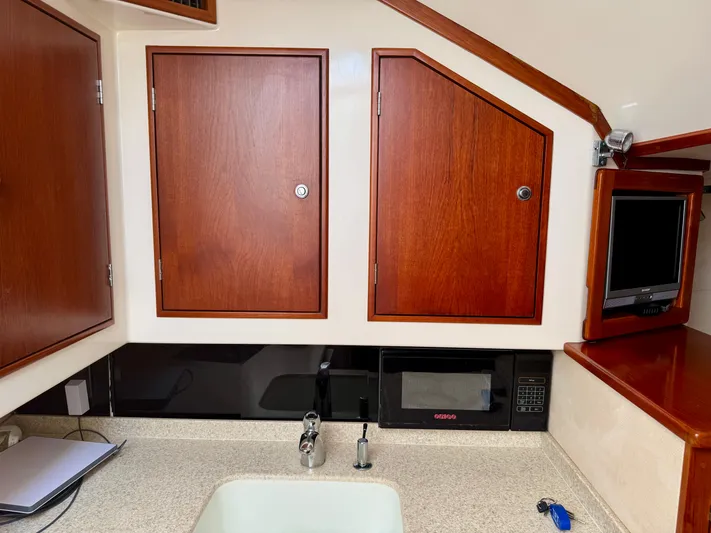 Pandemonium Yacht Photos Pics Wooden cabinets and appliances in a 2000 Liberty 42 Express yacht kitchen.