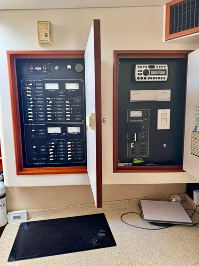 Pandemonium Yacht Photos Pics Electrical control panel on a 2000 Liberty 42 Express boat, featuring various switches and controls.