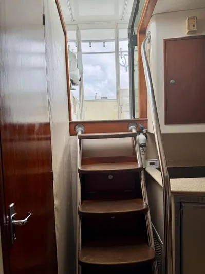 Pandemonium Yacht Photos Pics Interior stairs of 2000 Liberty 42 Express yacht, leading to upper deck.