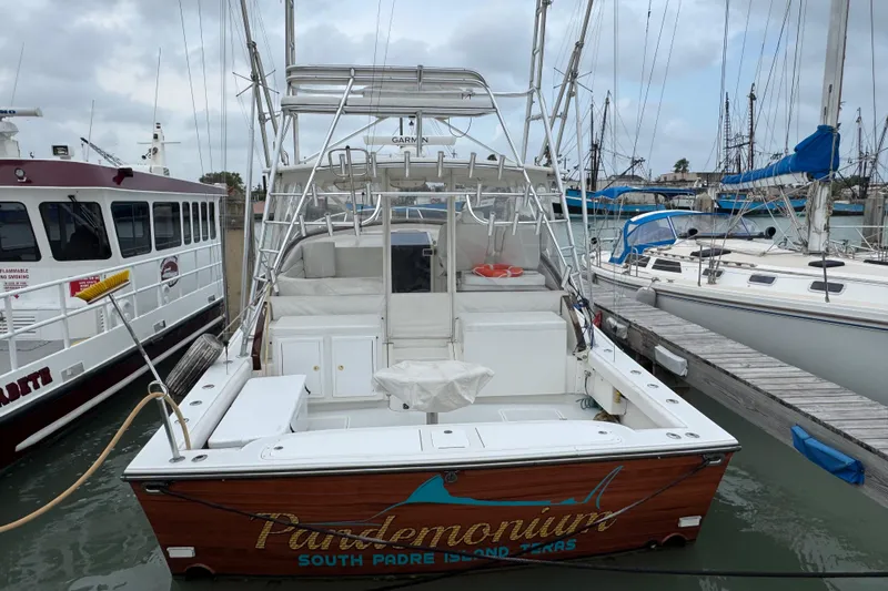 Pandemonium Yacht Photos Pics Liberty 42 Express 2000 boat docked, featuring fishing equipment and wooden detailing.