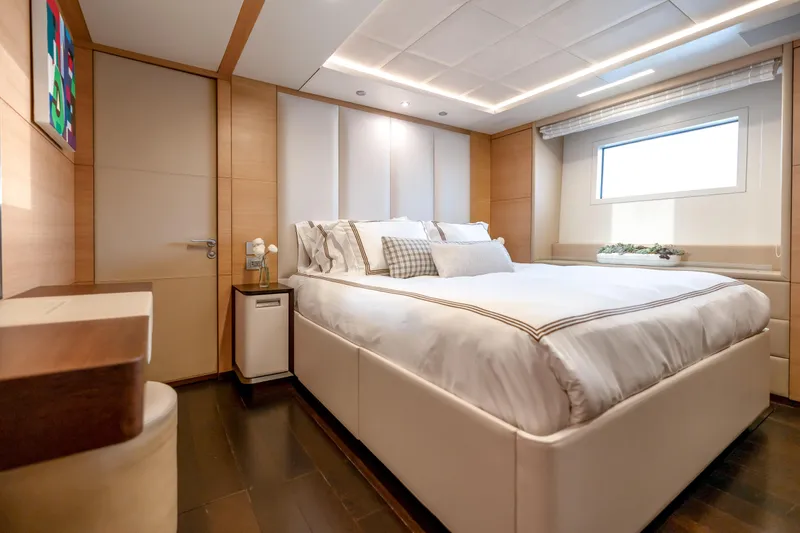 Patience Yacht Photos Pics Luxurious bedroom interior on 2012 Benetti Classic Supreme 132 yacht, featuring elegant design and cozy ambiance.