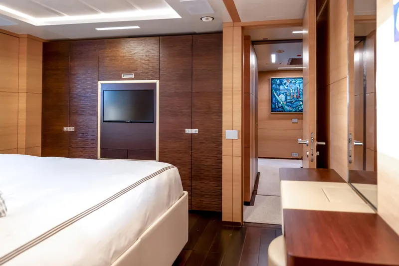Patience Yacht Photos Pics Luxurious bedroom interior on 2012 Benetti Classic Supreme 132 yacht, featuring modern wood finishes.