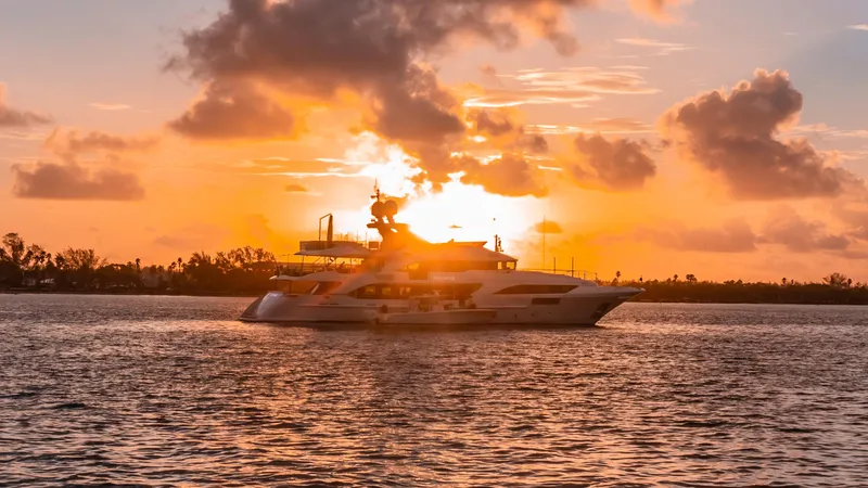 Patience Yacht Photos Pics Luxury yacht Benetti Classic Supreme 132 at sunset, 2012 model, cruising on serene waters.