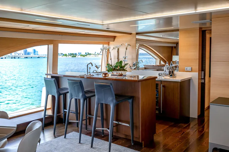 Patience Yacht Photos Pics Luxurious interior of 2012 Benetti Classic Supreme 132 yacht with elegant bar and ocean view.