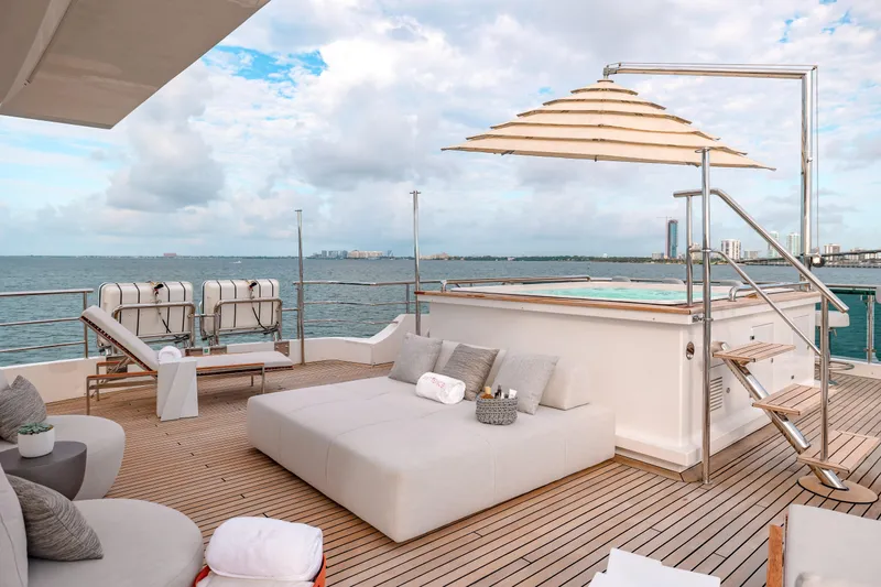 Patience Yacht Photos Pics Luxurious deck of 2012 Benetti Classic Supreme 132 yacht with sun loungers and ocean view.
