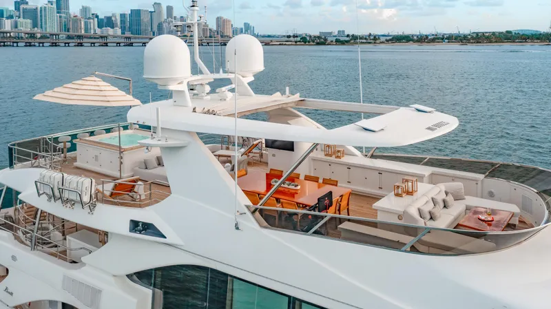 Patience Yacht Photos Pics Luxurious 2012 Benetti Classic Supreme 132 yacht with spacious deck, city skyline in background.