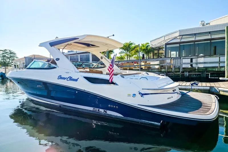  Yacht Photos Pics 2015 Sea Ray 350 SLX boat docked, featuring sleek design and American flag.
