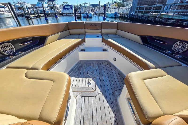  Yacht Photos Pics Luxurious 2015 Sea Ray 350 SLX boat interior with tan seating and wood flooring at a marina.
