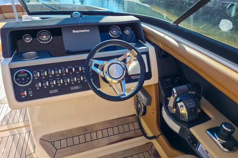  Yacht Photos Pics Cockpit of 2015 Sea Ray 350 SLX with steering wheel and control panel.