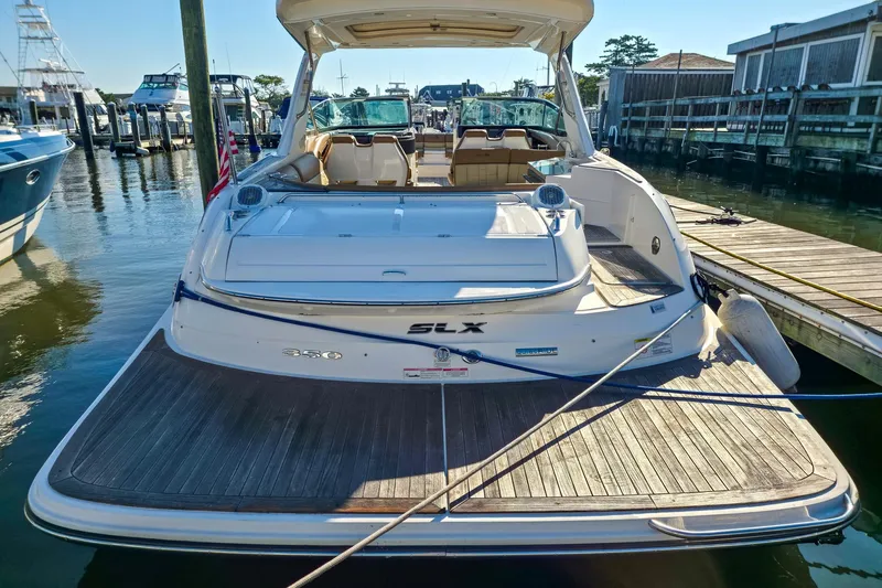 Yacht Photos Pics 2015 Sea Ray 350 SLX boat docked at marina, rear view with spacious deck.