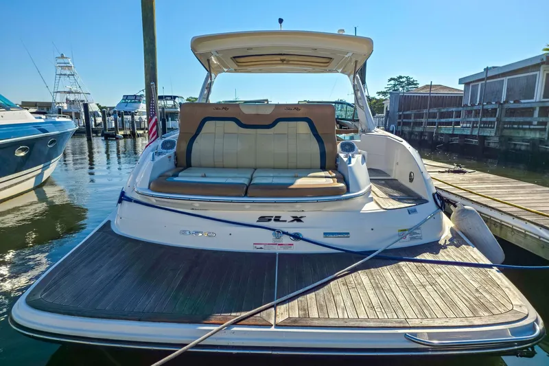  Yacht Photos Pics 2015 Sea Ray 350 SLX boat docked at marina, rear view with seating area.