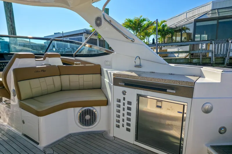  Yacht Photos Pics Luxurious interior of 2015 Sea Ray 350 SLX boat with seating and kitchenette.