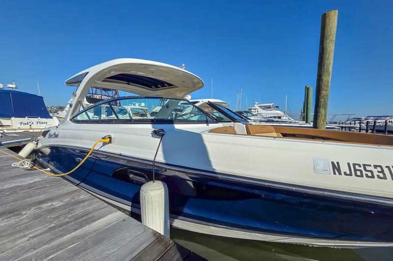  Yacht Photos Pics 2015 Sea Ray 350 SLX boat docked at marina under clear blue sky.