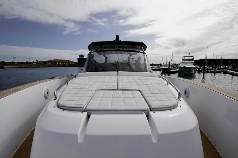  Yacht Photos Pics 2023 Pardo Yachts model with sleek design, docked in a marina under a cloudy sky.