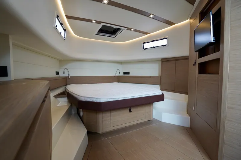  Yacht Photos Pics Luxurious cabin interior of 2023 Pardo Yachts, featuring modern design and cozy bed.
