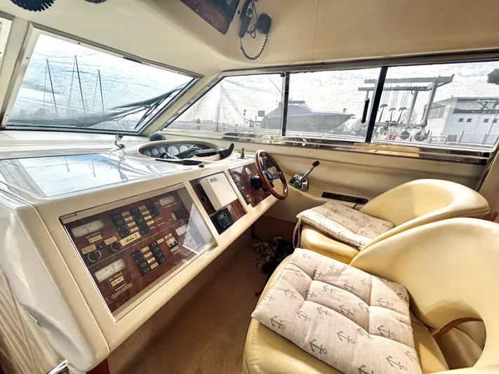  Yacht Photos Pics Interior of a 1994 Princess 45 Flybridge yacht with helm and cushioned seats.